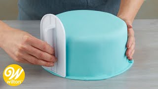 How to Cover a Round Cake with Fondant  Wilton [upl. by Retxab]