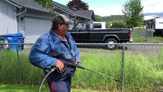 Moss man hydrotilling cutting tall grass through a fence tilling with a pressure washer garden [upl. by Elstan]